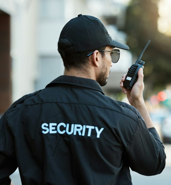 Radio, man and a security guard or safety officer outdoor on a city road for communication. Back of